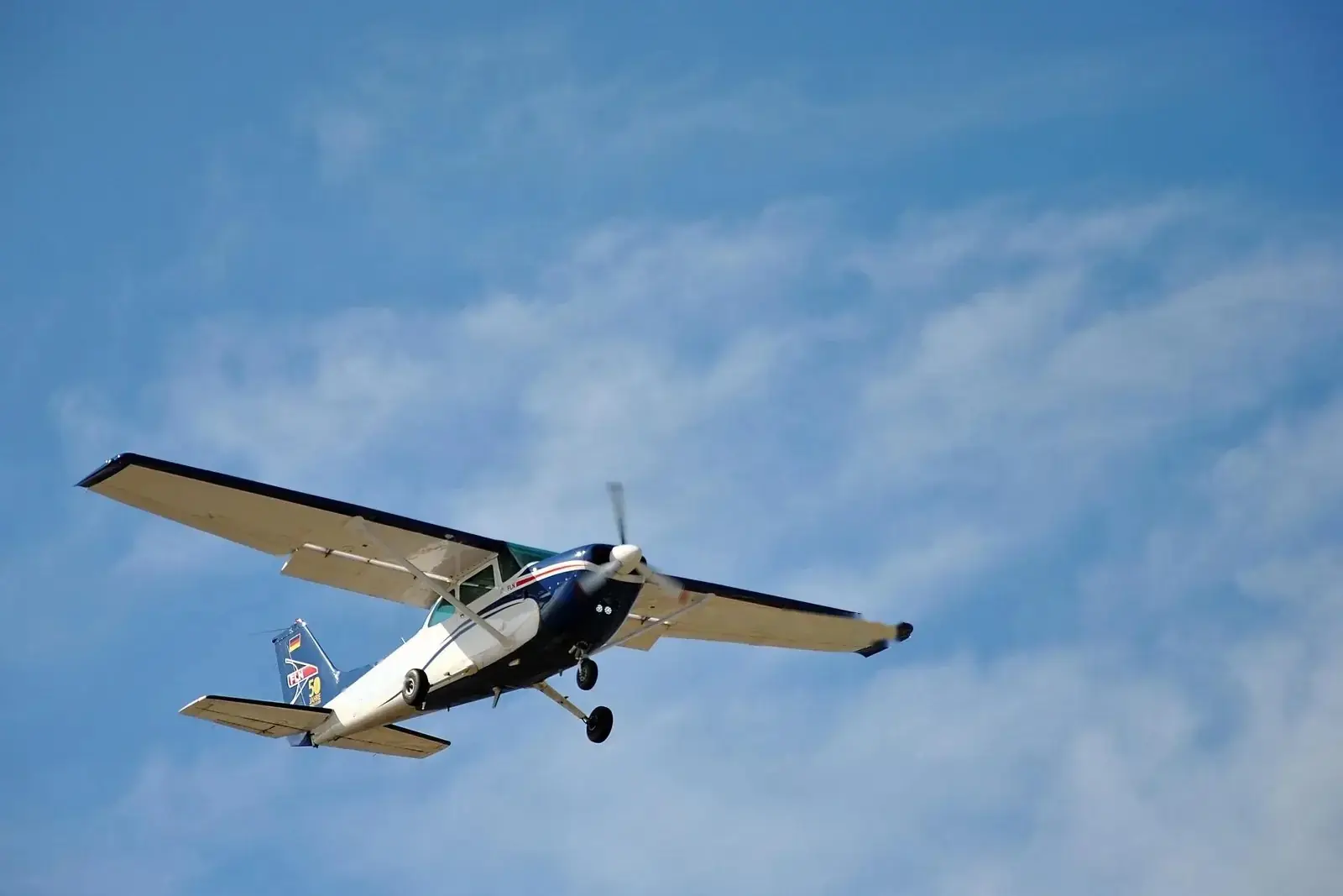 Cessna single-engine aircraft climbing after take-off